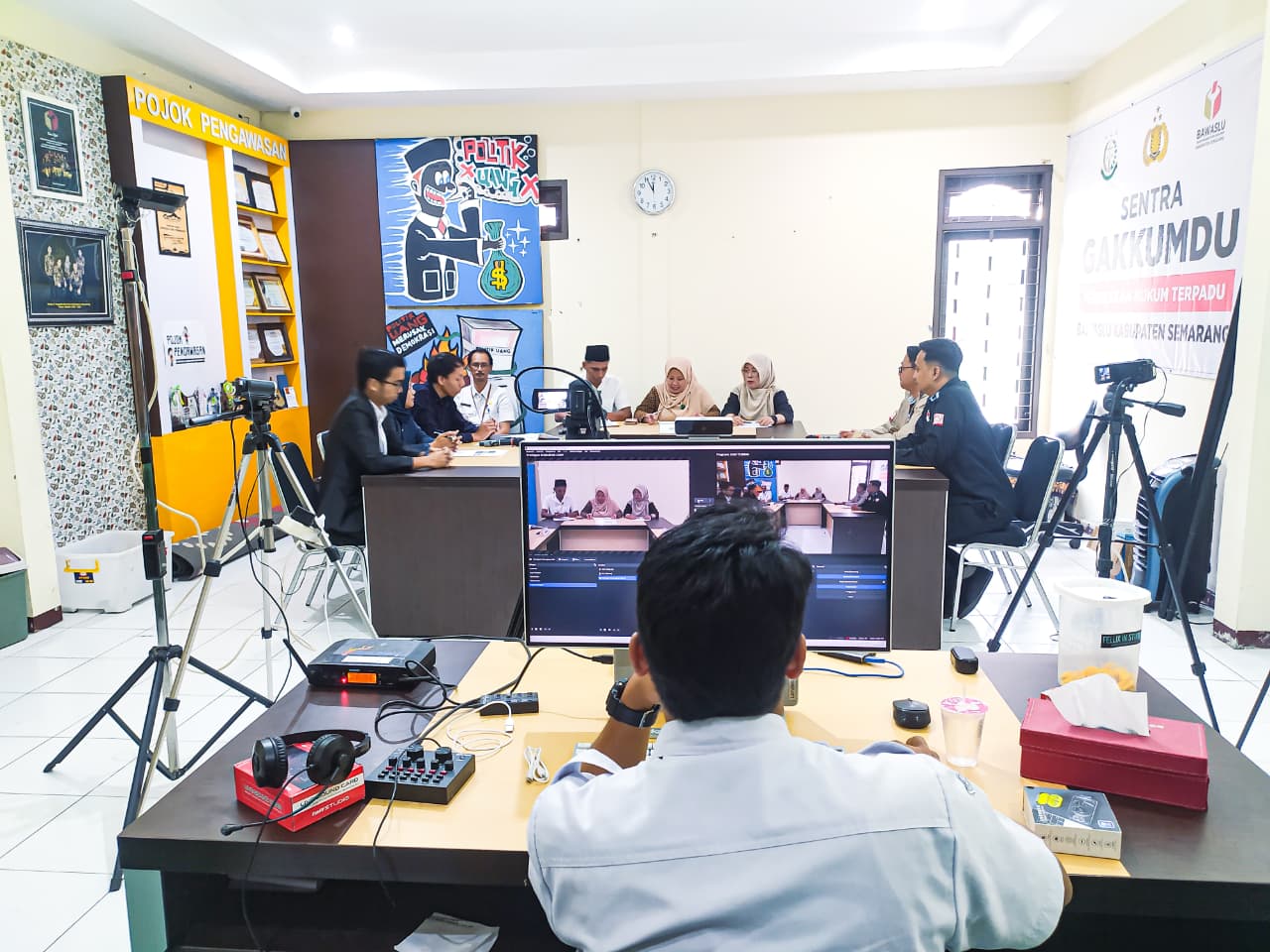Suasana pengambilan video simulasi penyelesaian sengketa proses di Bawaslu Kabupaten Semarang dengan jajaran sidang dan tim produksi yang sedang menjalankan peran masing-masing.